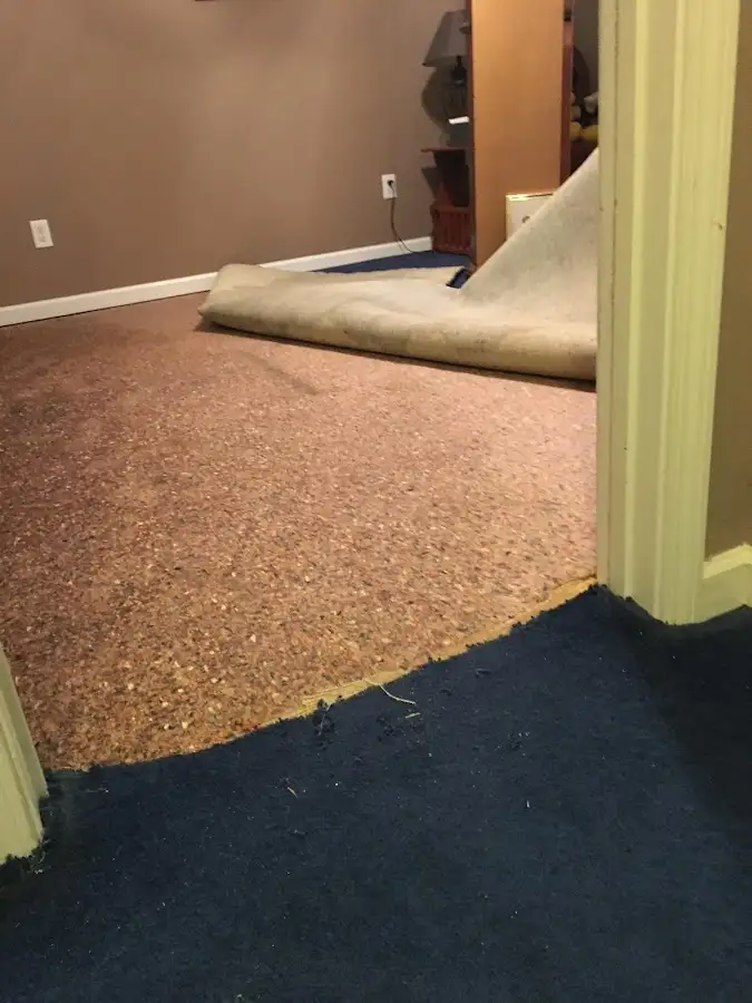 Carpet pad removal revealing water damage during Water Mitigation Services in Pasadena Hills
